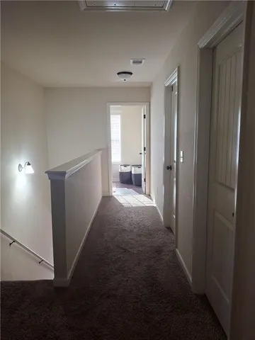 a view of a hallway with bathroom