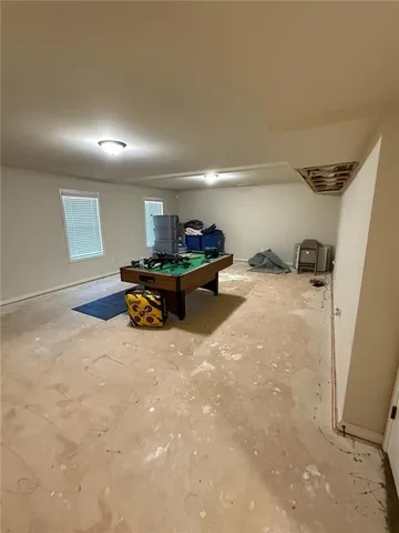 an empty room with projector and a couch