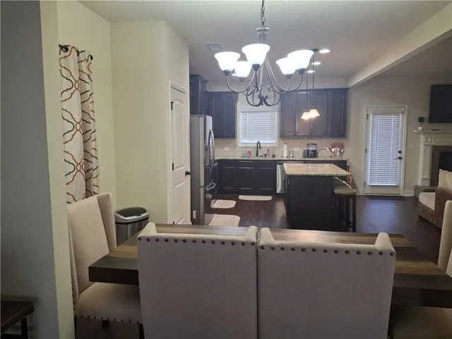 a view of a dining room with furniture and chandelier