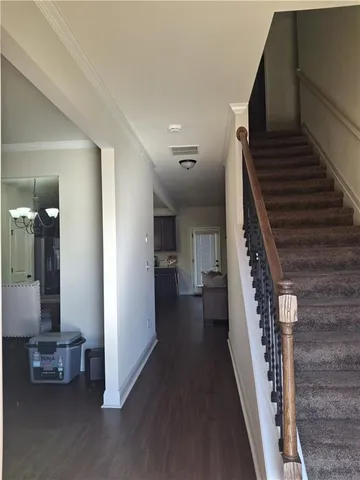 a view of entryway and hall with wooden floor