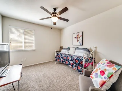 a bedroom with bed and a chandelier