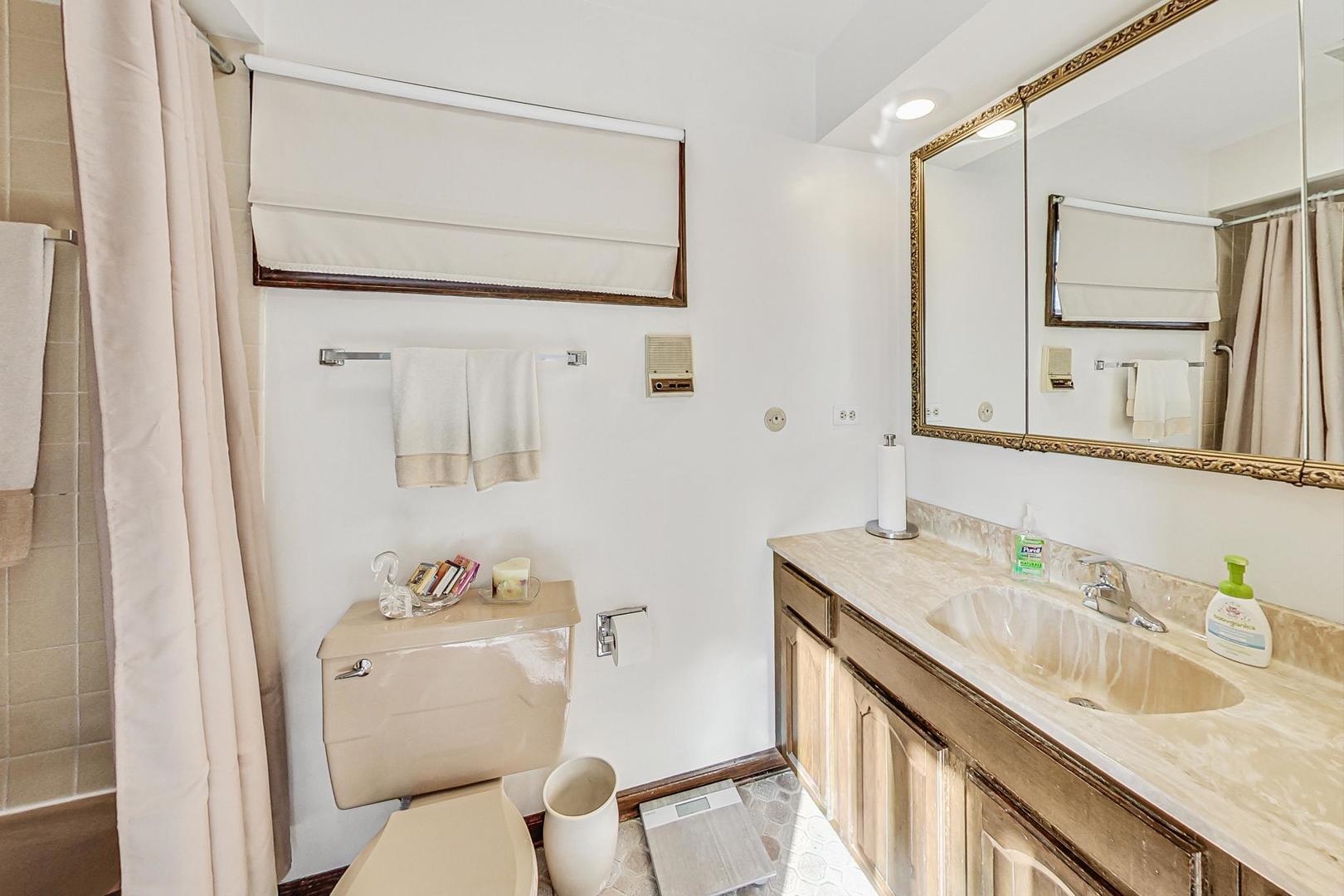 802 Prairie Lawn Road Glenview, IL 60025 - Photo 20 of 36 a bathroom with a granite countertop sink mirror and a