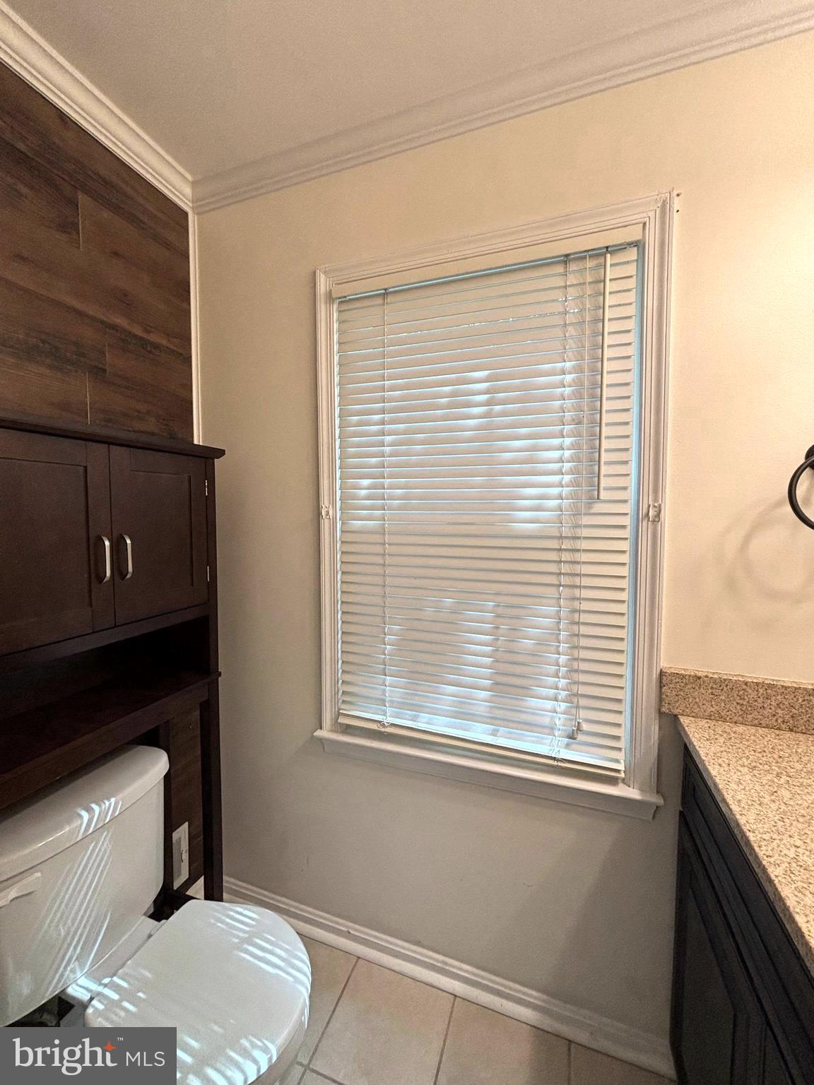 2847 Seminole Road Woodbridge, VA 22192 - Photo 11 of 38 a bathroom with a toilet a sink and a window