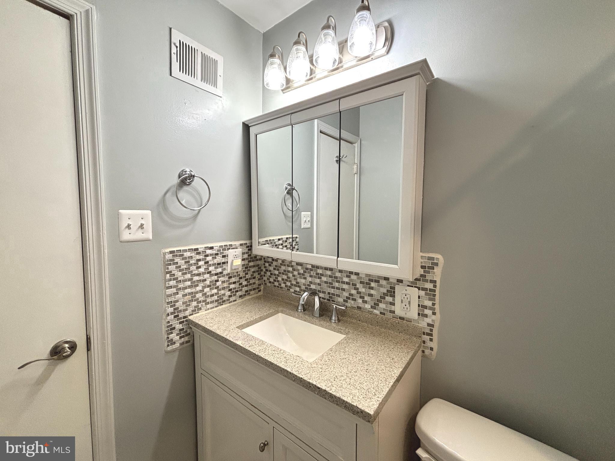 2847 Seminole Road Woodbridge, VA 22192 - Photo 15 of 38 a bathroom with a sink toilet and mirror