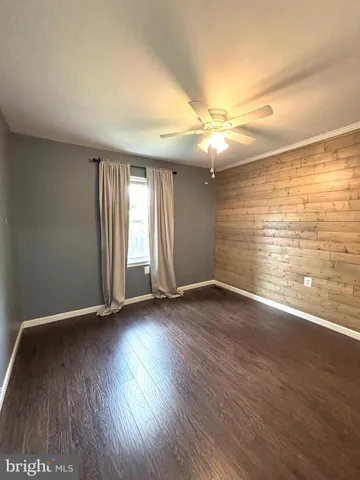 an empty room with furniture and a fireplace