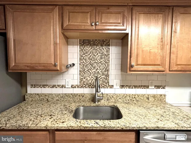 a kitchen with granite countertop a sink and a window