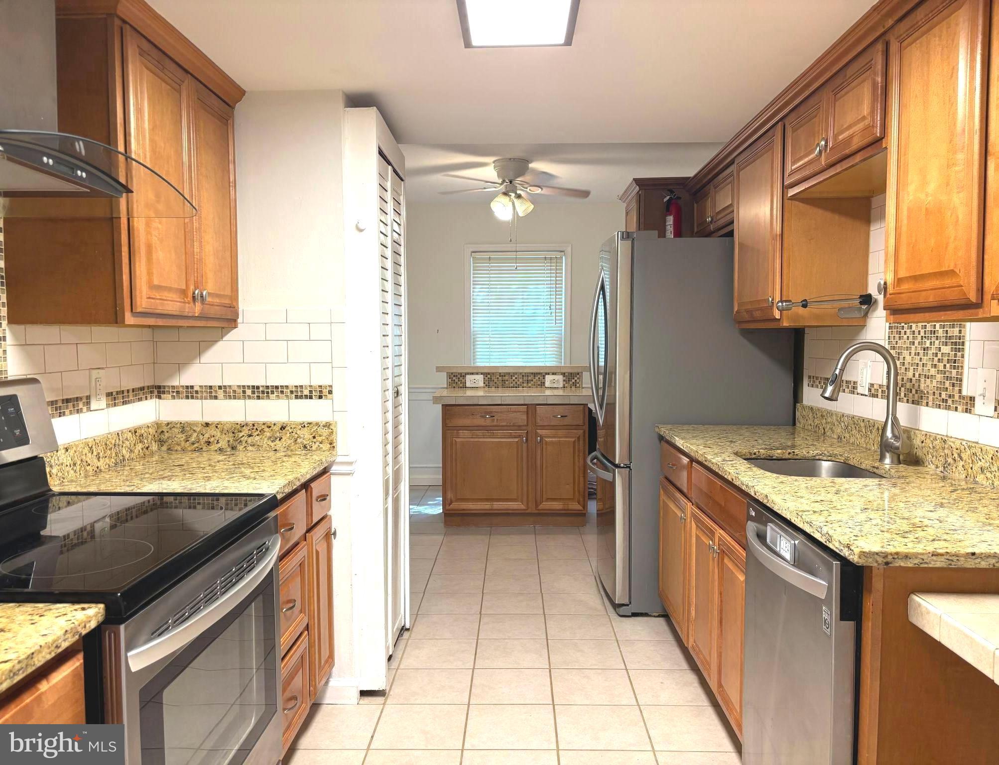 2847 Seminole Road Woodbridge, VA 22192 - Photo 9 of 38 a kitchen with a sink stove and cabinets