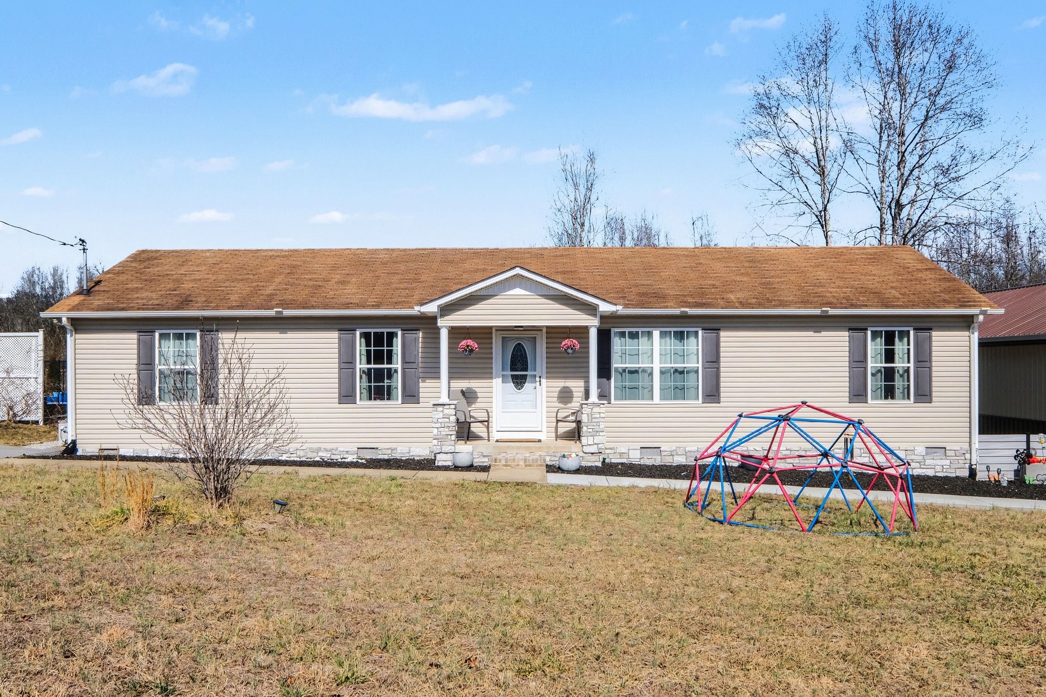 870 Newt Vanattia Road Hillsboro, TN 37342 - Photo 6 of 32 a front view of house with yard outdoor seating and barbeque oven in the background