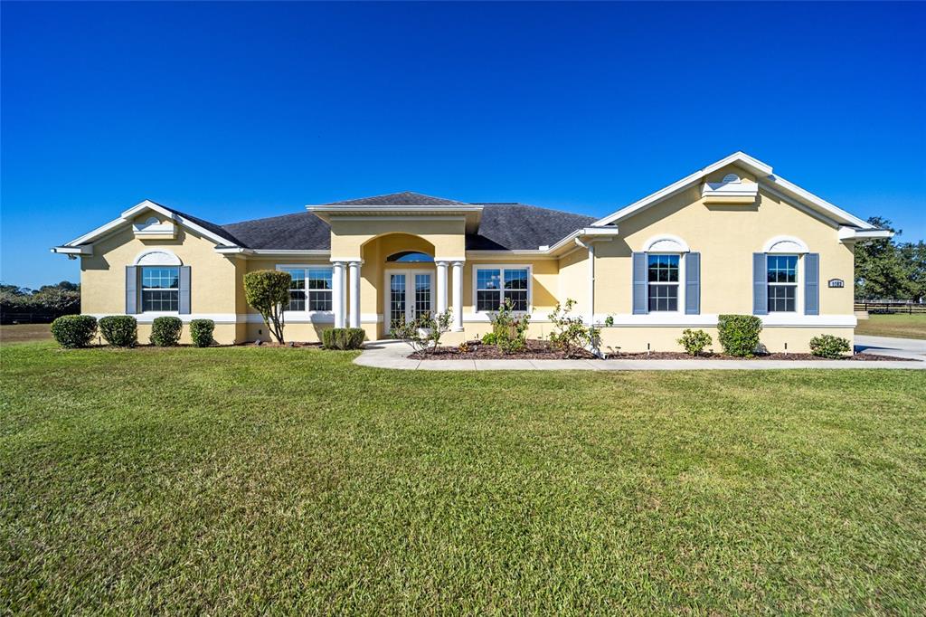 9502 Southwest 27th Avenue Ocala, FL 34476 - Photo 1 of 1 a front view of a house with a garden