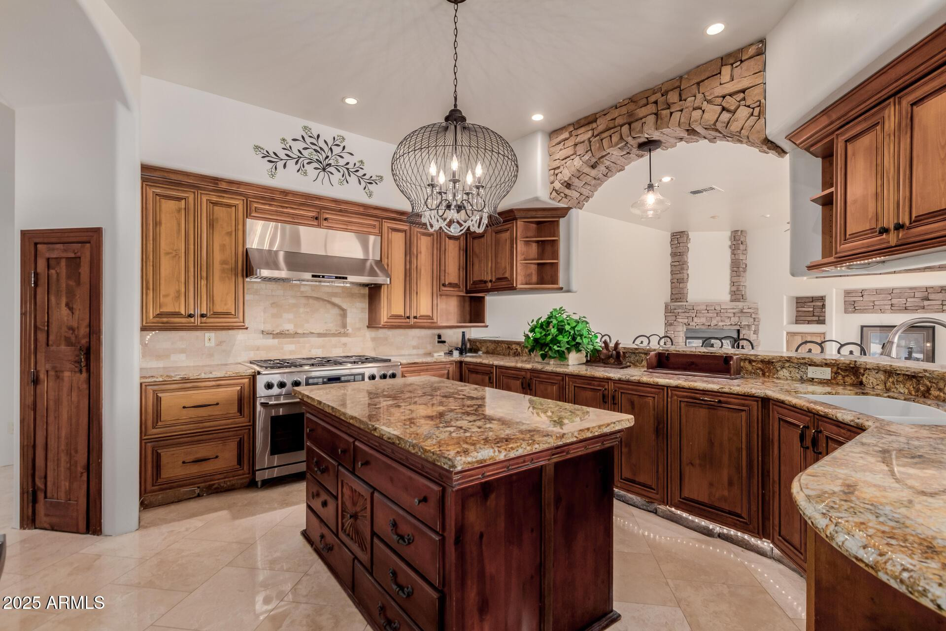 8540 East McDowell Road, Unit 121 Mesa, AZ 85207 - Photo 11 of 35 a kitchen with stainless steel appliances granite countertop a stove and a center island