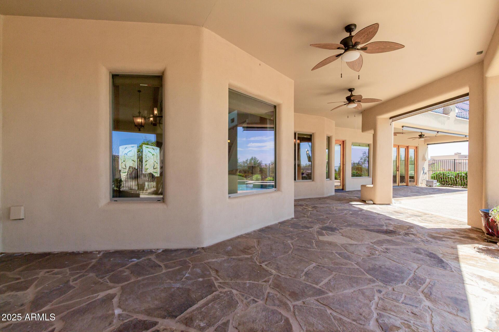 8540 East McDowell Road, Unit 121 Mesa, AZ 85207 - Photo 34 of 35 a view of a hallway with a chandelier fan and windows