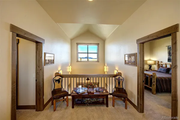 a bedroom with a bed and large windows
