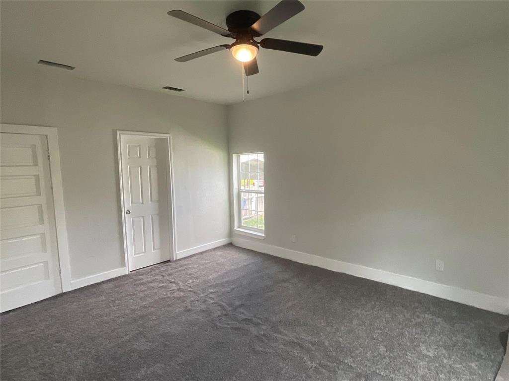 207 College Street Chico, TX 76431 - Photo 17 of 20 Unfurnished bedroom with dark colored carpet and ceiling fan