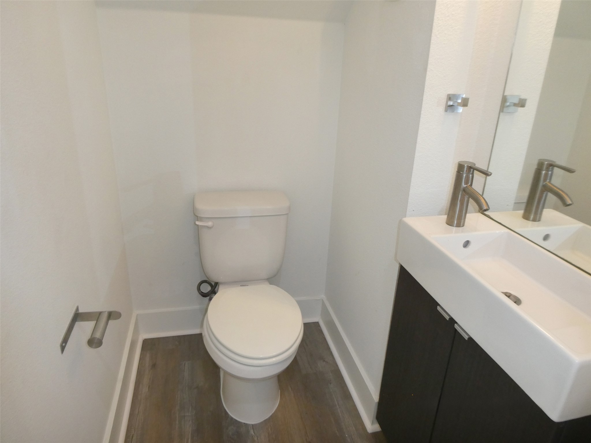 2512 Wheless Lane, Unit 5 Austin, TX 78723 - Photo 12 of 21 a white toilet sitting next to a bathroom sink