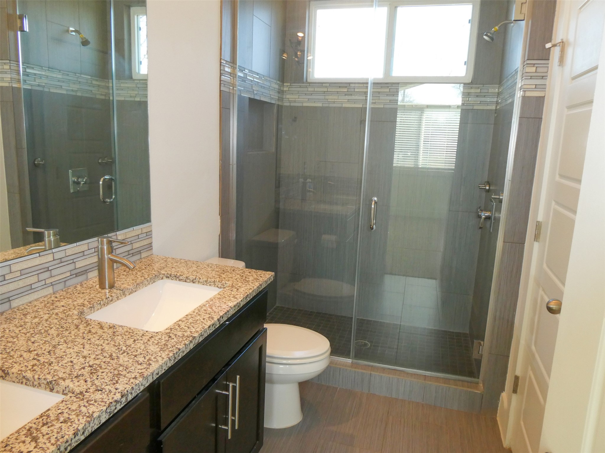 2512 Wheless Lane, Unit 5 Austin, TX 78723 - Photo 14 of 21 a bathroom with a granite countertop sink toilet a mirror and shower