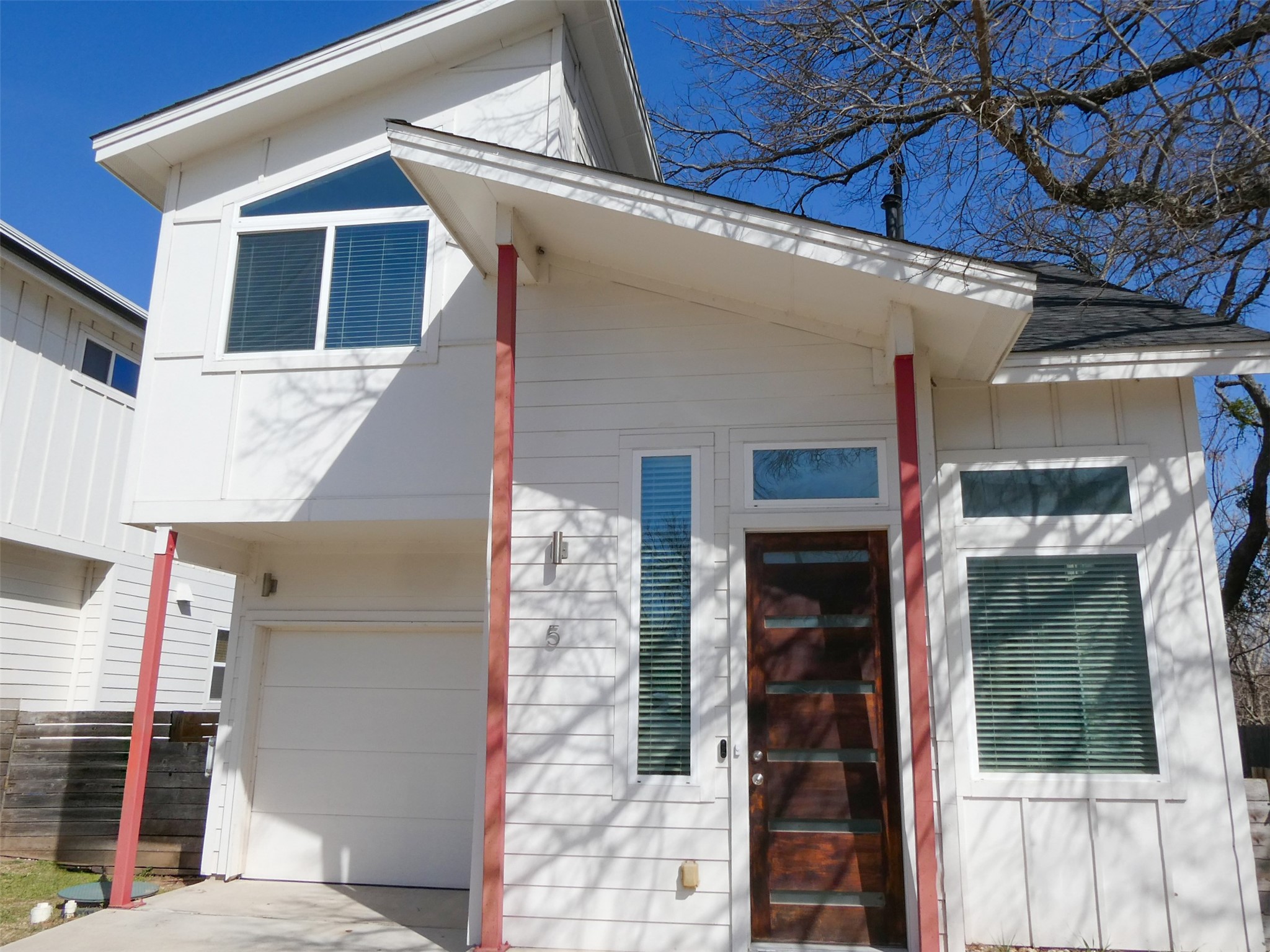 2512 Wheless Lane, Unit 5 Austin, TX 78723 - Photo 2 of 21 a view of a house with a door and wooden walls