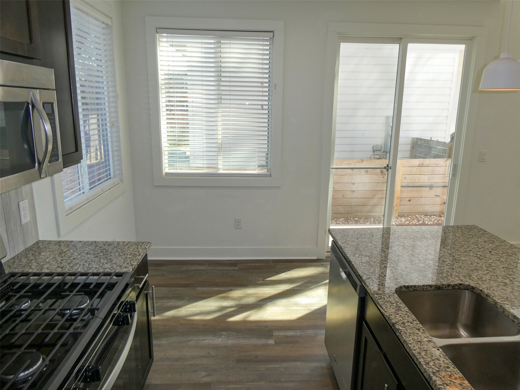 2512 Wheless Lane, Unit 5 Austin, TX 78723 - Photo 4 of 21 a kitchen with granite countertop a sink and a stove