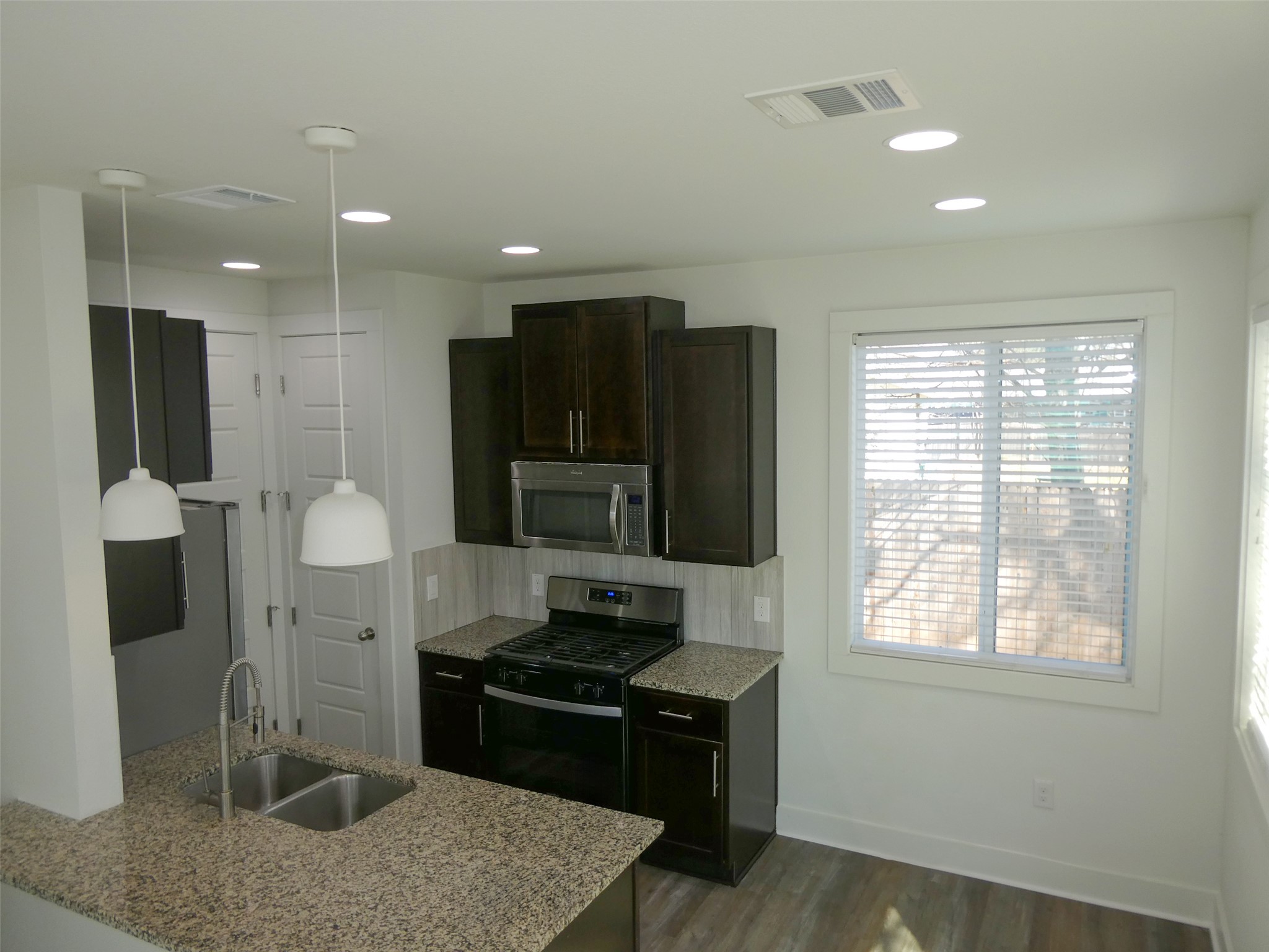 2512 Wheless Lane, Unit 5 Austin, TX 78723 - Photo 8 of 21 a kitchen with stainless steel appliances granite countertop a stove and a refrigerator
