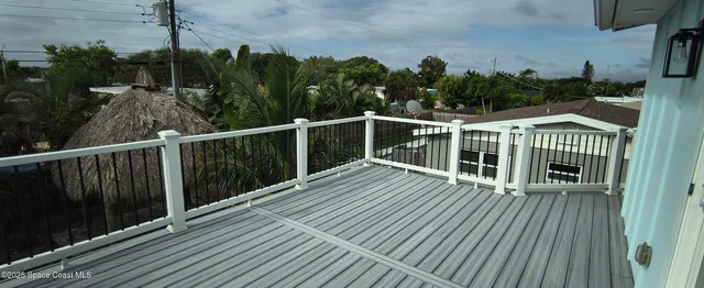 a view of a balcony with wooden floor