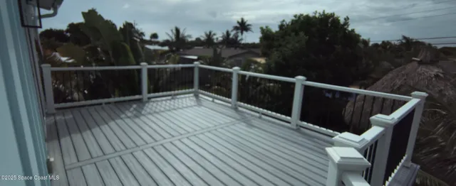 a view of deck with furniture and trees