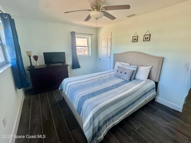 a bedroom with bed and window