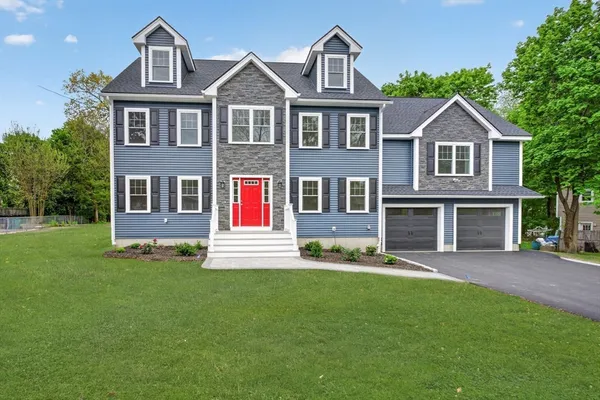 a front view of a house with a yard
