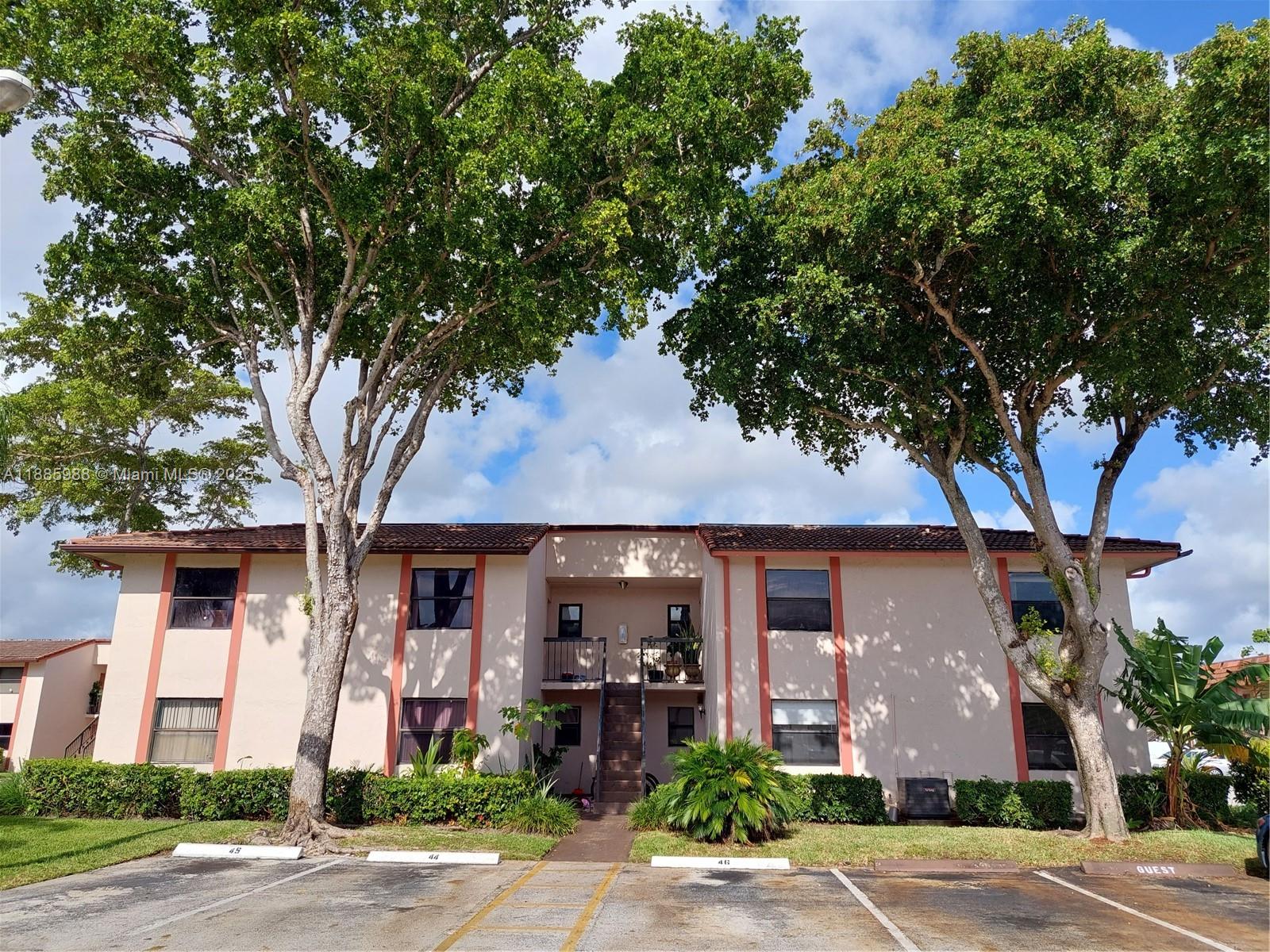 front view of a house with a tree