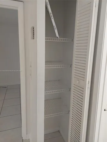 a view of an empty room with a floor to ceiling window