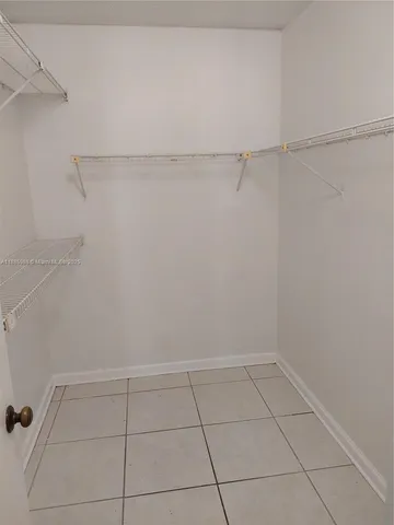 a view of kitchen with furniture and white cabinets