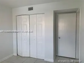 a view of a house with a flower garden