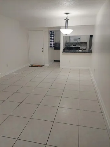 a view of kitchen island with stainless steel appliances granite countertop a sink and a stove