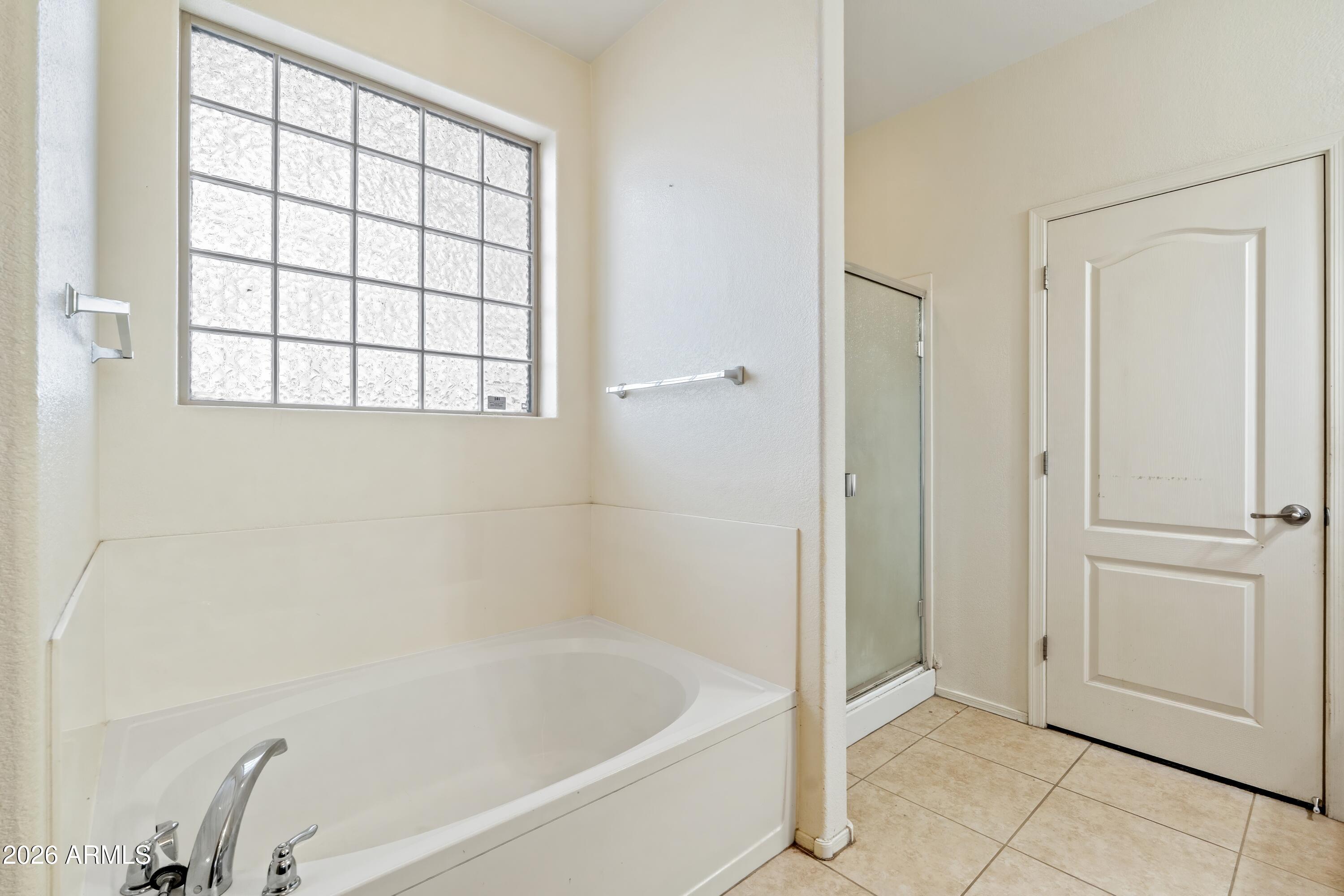 7634 West Apollo Road Laveen, AZ 85339 - Photo 22 of 34 a white bath tub sitting next to a window