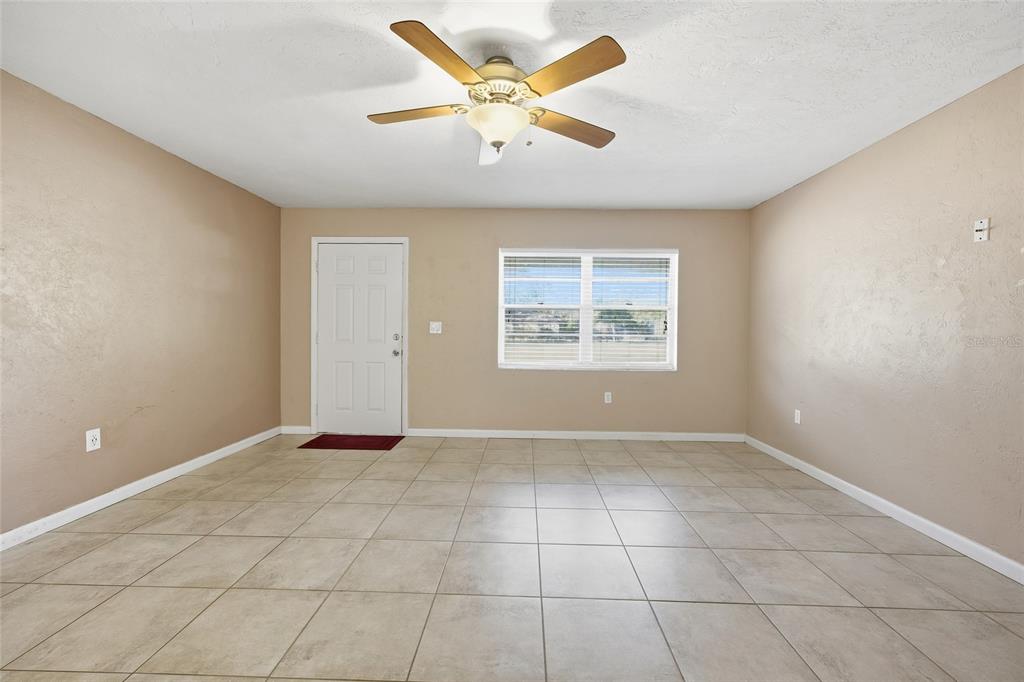 2140 Northeast 39th Street Ocala, FL 34479 - Photo 12 of 28 an empty room with windows and ceiling fan