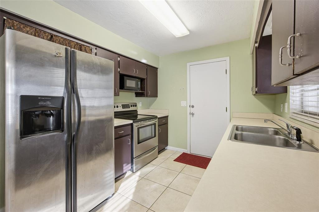 2140 Northeast 39th Street Ocala, FL 34479 - Photo 16 of 28 a kitchen with granite countertop a refrigerator and a sink