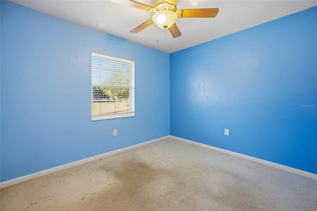 2140 Northeast 39th Street Ocala, FL 34479 - Photo 20 of 28 an empty room with chandelier fan and windows