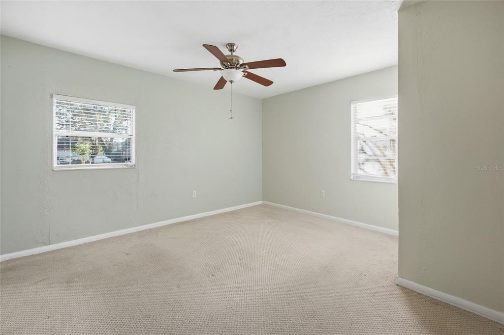 2140 Northeast 39th Street Ocala, FL 34479 - Photo 25 of 28 an empty room with windows and fan