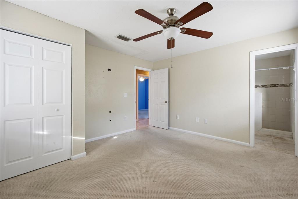 2140 Northeast 39th Street Ocala, FL 34479 - Photo 26 of 28 an empty room with closet and a ceiling fan