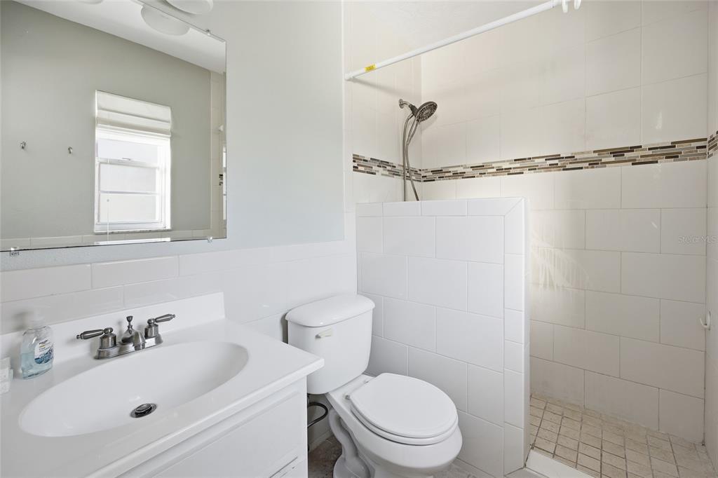 2140 Northeast 39th Street Ocala, FL 34479 - Photo 27 of 28 a bathroom with a sink a toilet and shower