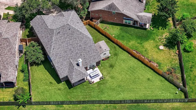 an aerial view of a house with a garden and swimming pool