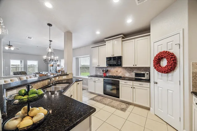 a dining room with furniture a chandelier and wooden floor