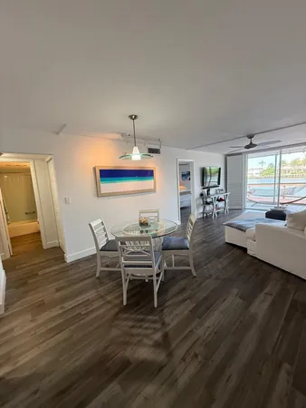 a view of a dining room with furniture and wooden floor