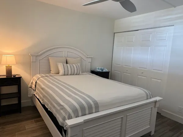 a bedroom with a bed and a mirror