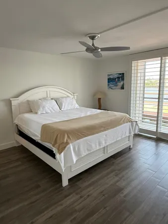 a large bed sitting in a bedroom next to a window