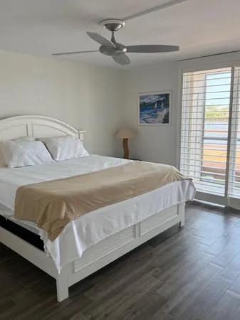 a bedroom with a bed and a large window