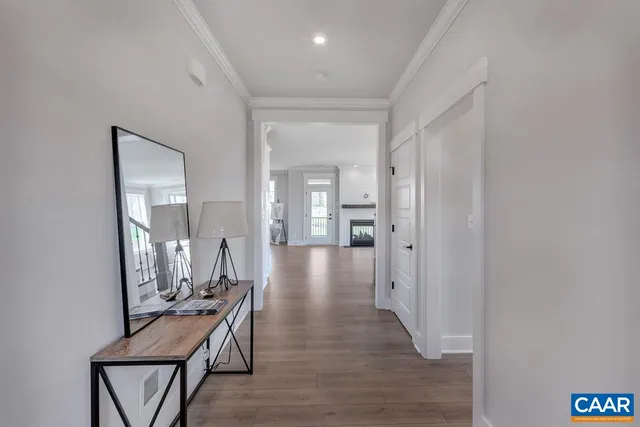 a view of a hallway to a livingroom and furniture