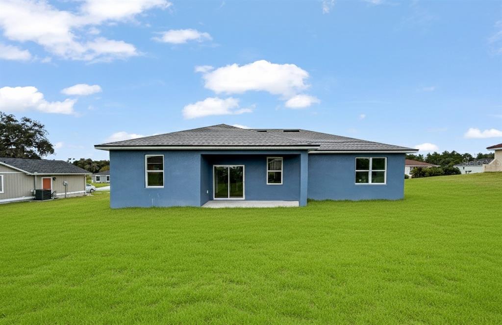 16212 Southwest 48th Circle Ocala, FL 34473 - Photo 3 of 17 a house that has a big yard in front of it