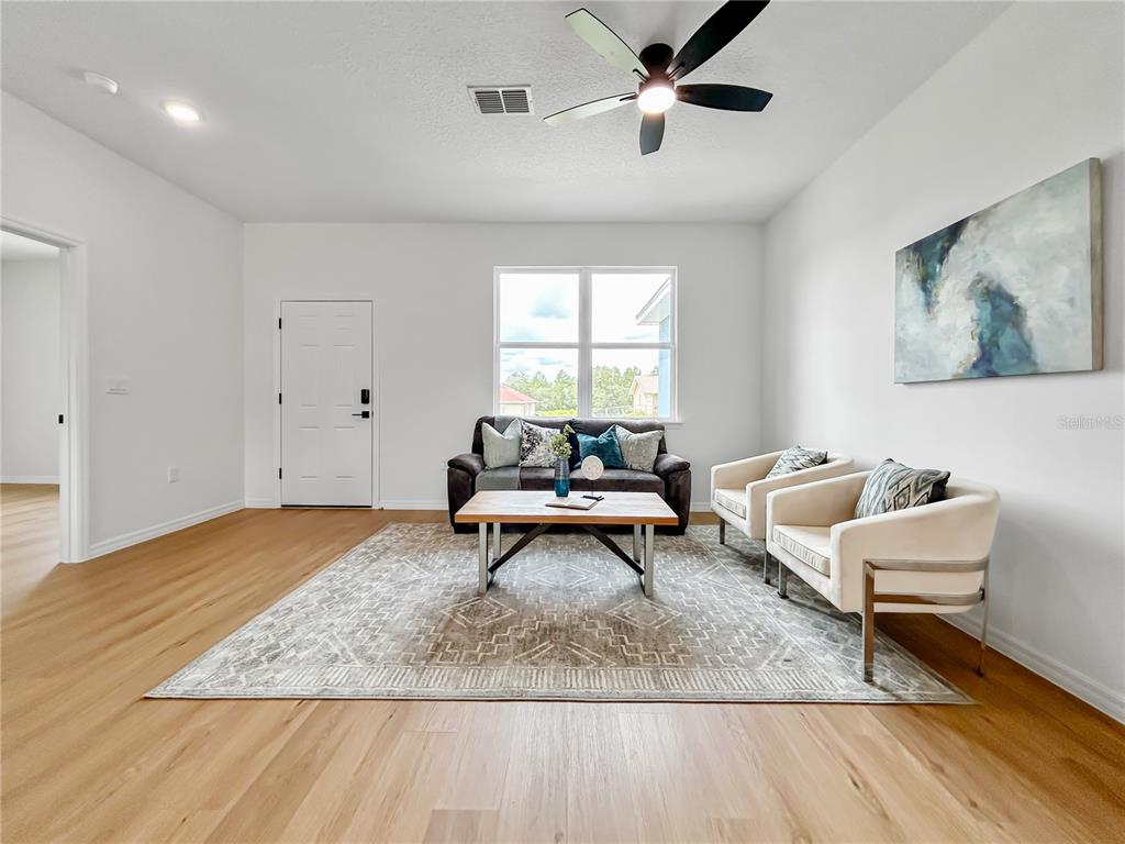 16212 Southwest 48th Circle Ocala, FL 34473 - Photo 4 of 17 a living room with furniture rug and window