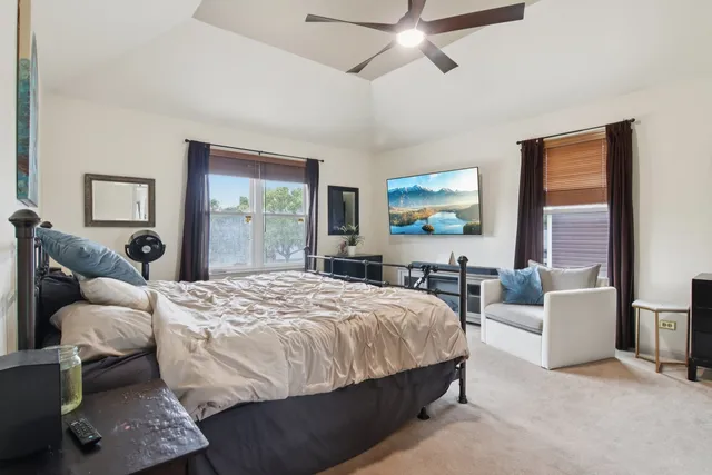 a bedroom with a bed and a large window