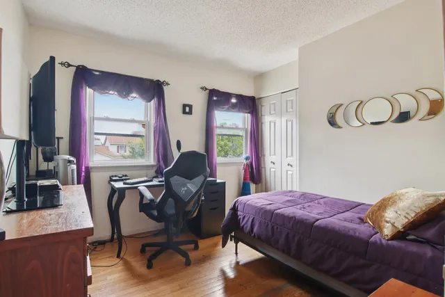 a bedroom with a bed and a desk