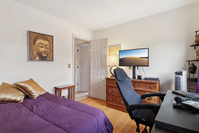 a bedroom with furniture and a flat screen tv
